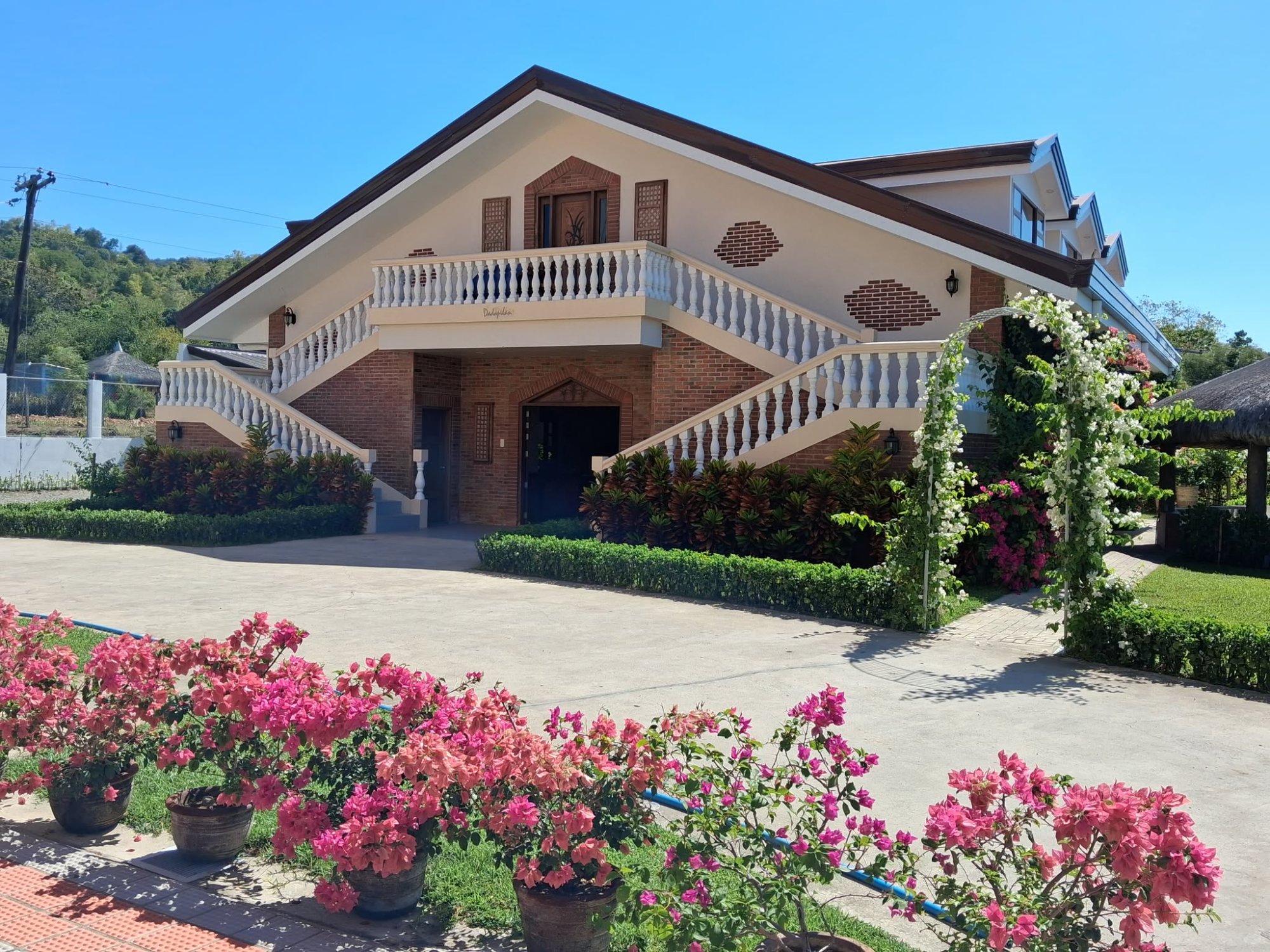 Dadapilan Hotel exterior with bougainvillea